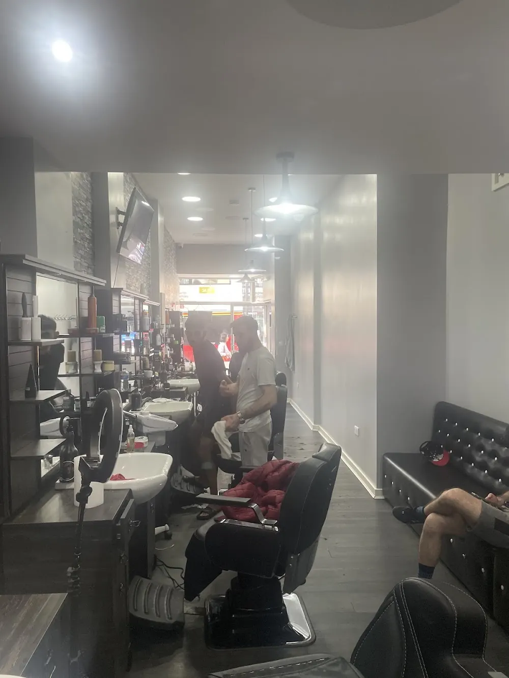 Inside the shop: the row of chairs and mirrors
